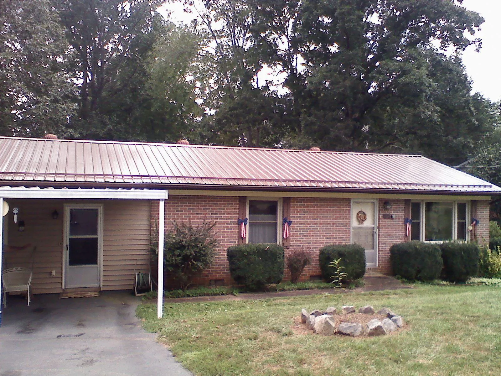 Bronze metal roof and carport on a brick ranch home — Roof Repair work by our crew in Huntingdon Valley