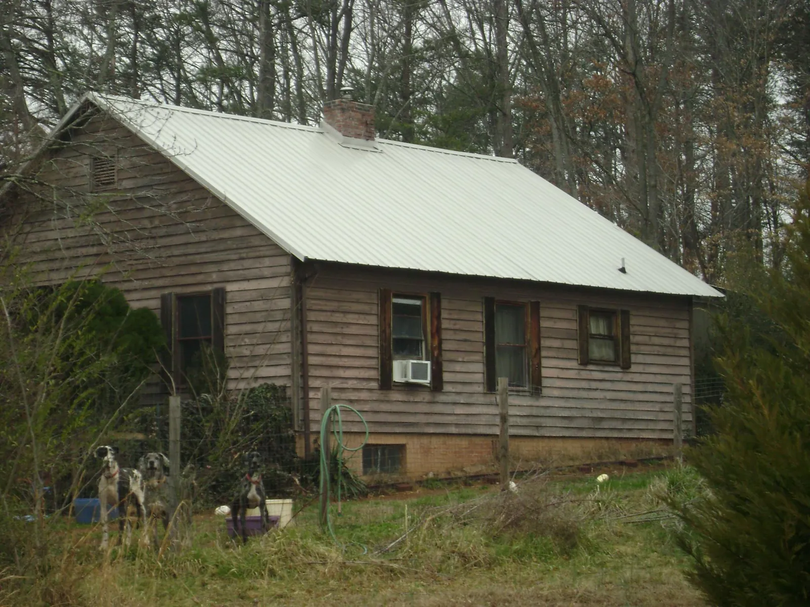 White metal roof on an old wood sided farmhouse, from a Metal Roof Installation job in Huntingdon Valley